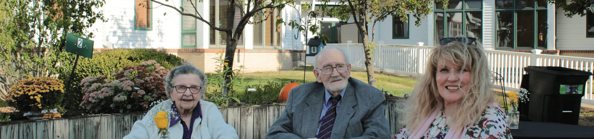 Young Woman And Older Couple Sit Together